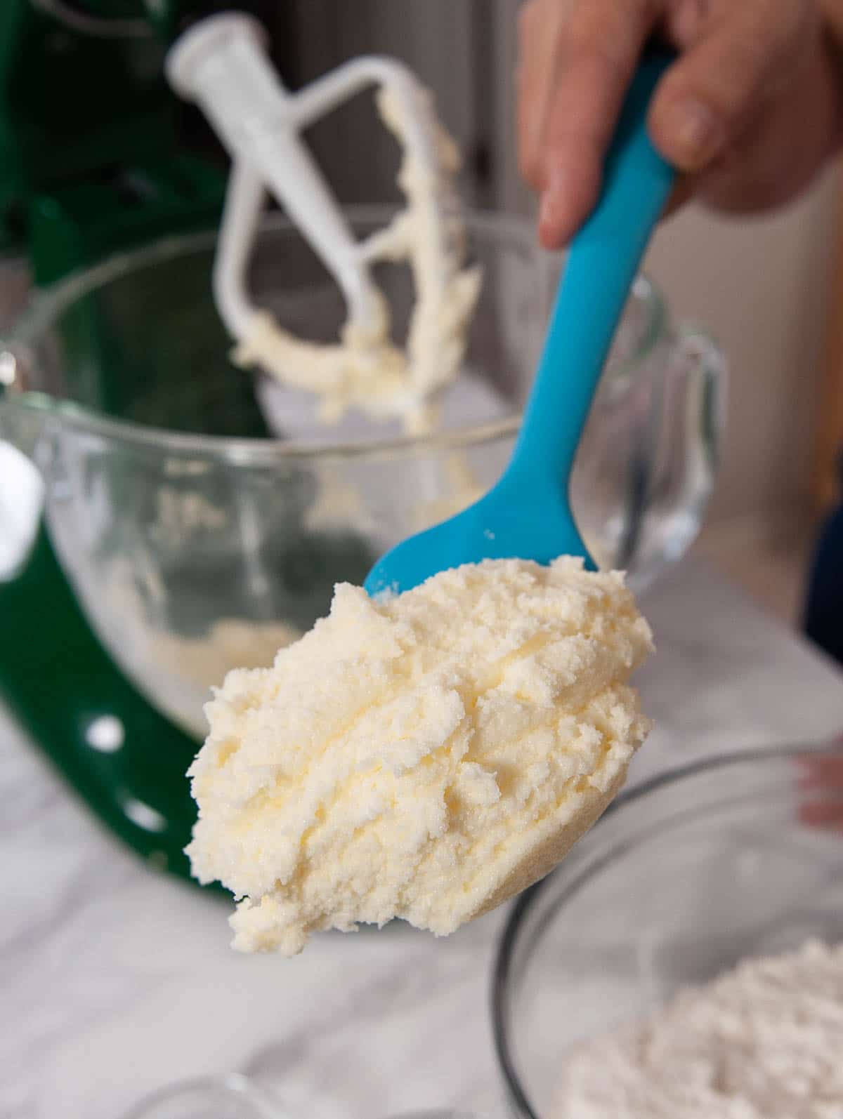 close up of butter and sugar creamed on a blue spatula