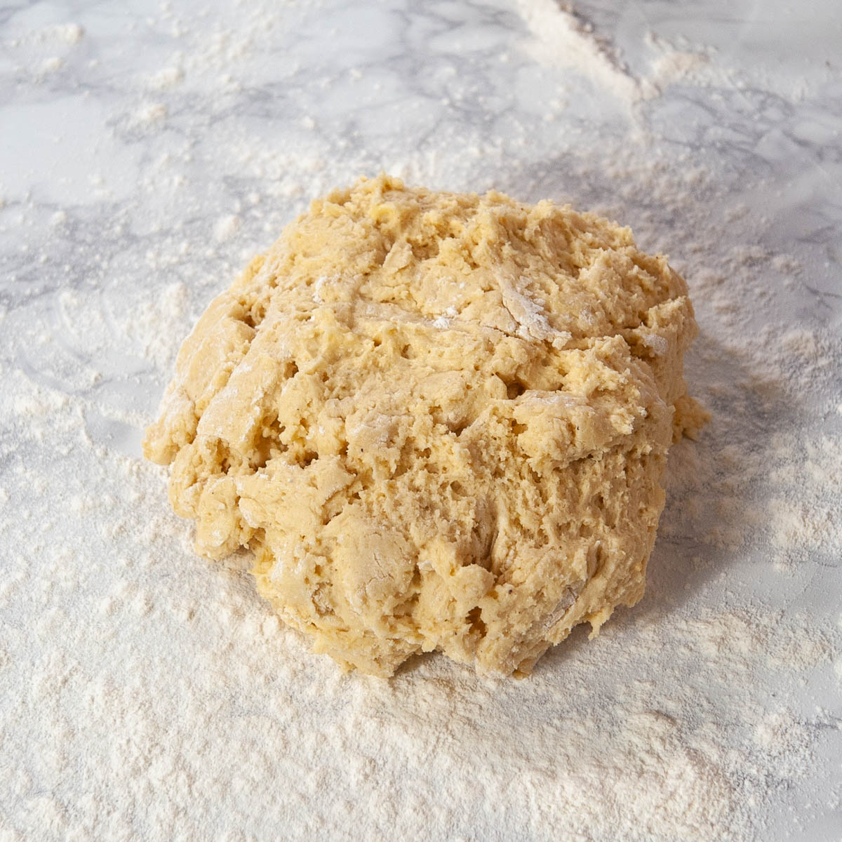 cake donut dough on a floured countertop