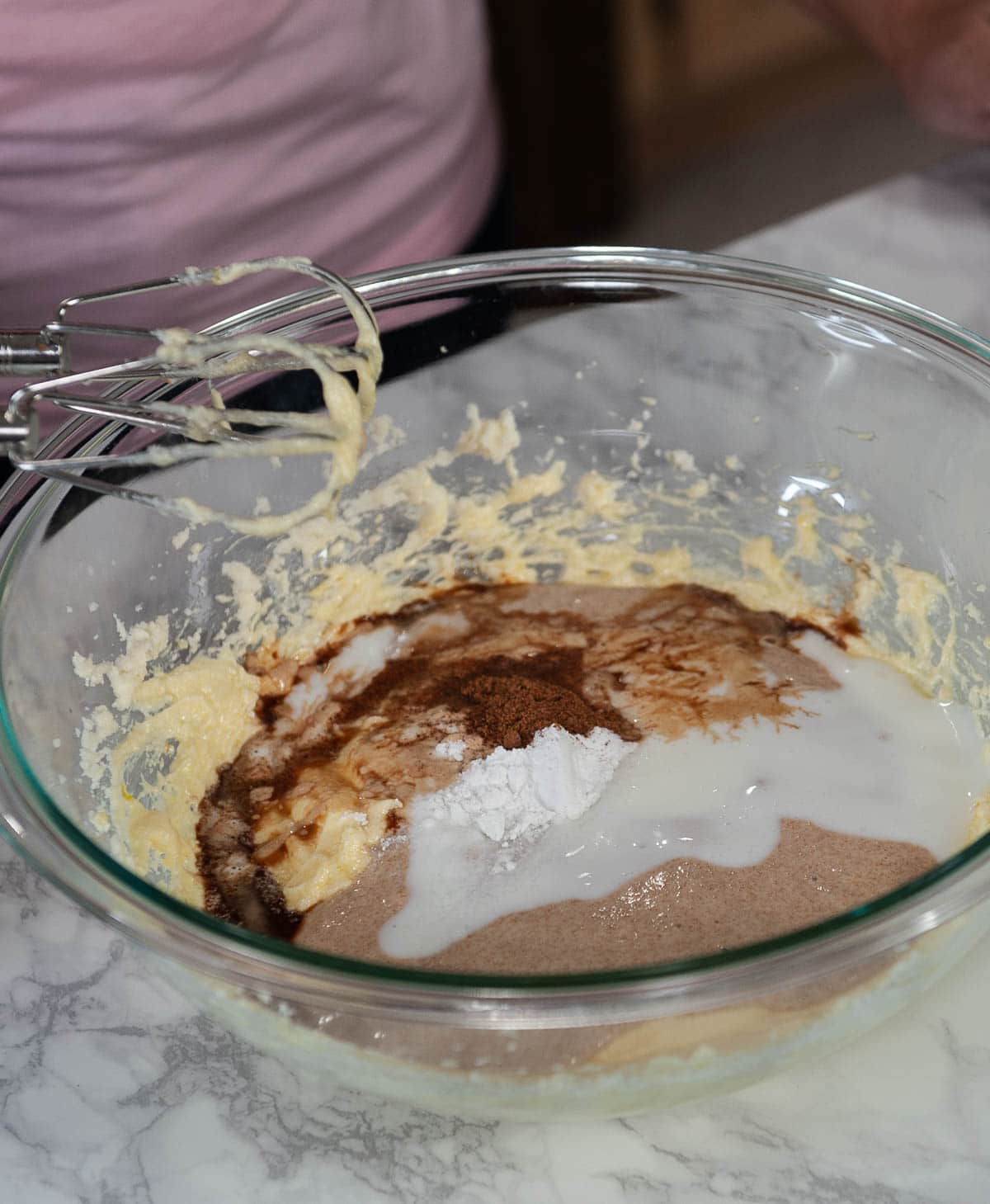 mixing sourdough donut ingredients in a glass bowl