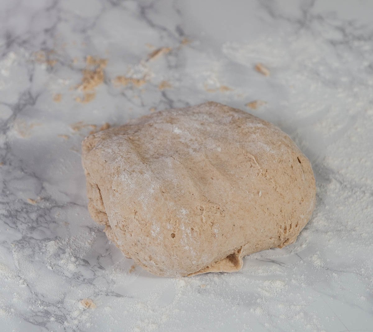 sourdough donut dough on a floured white table