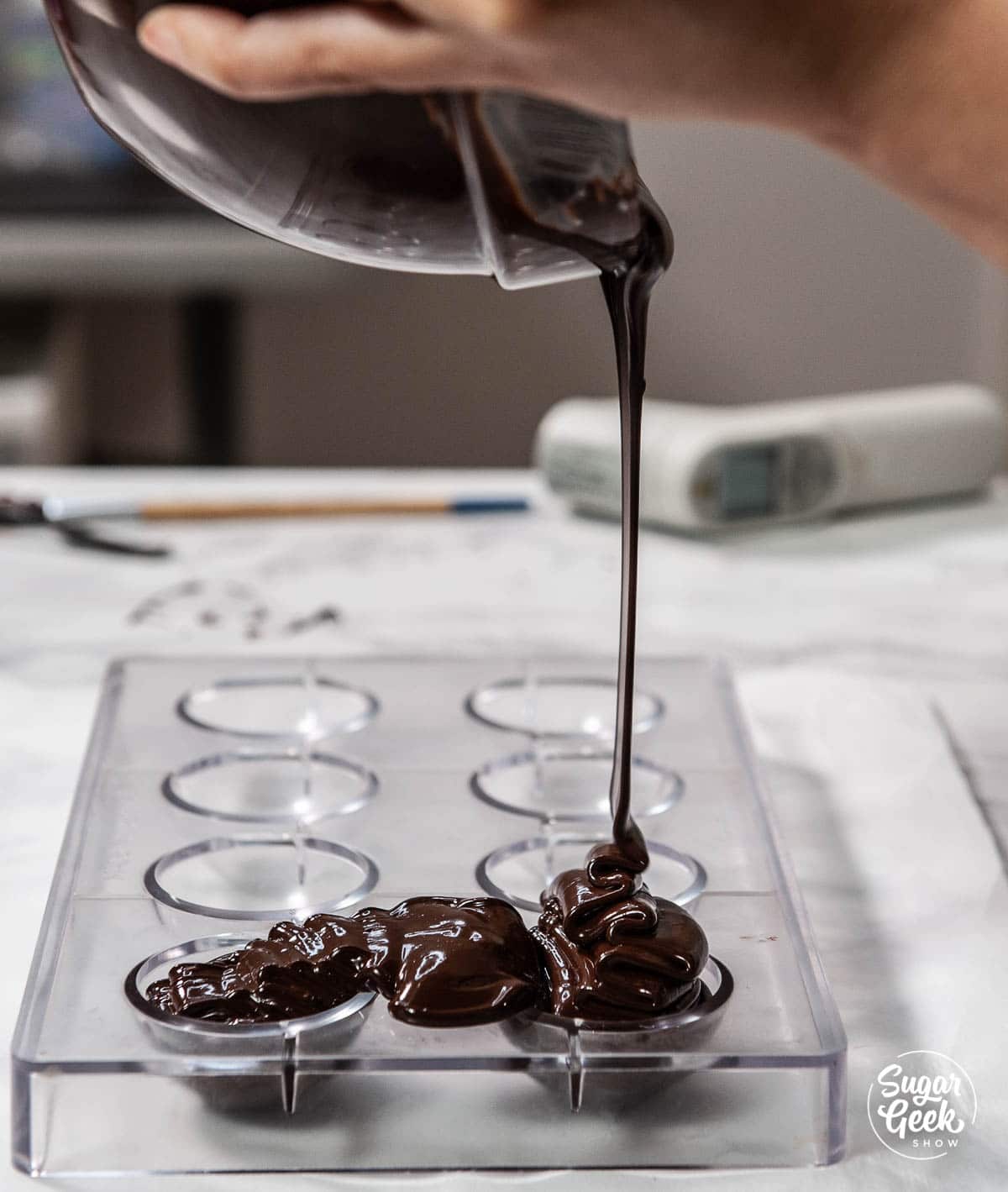 pouring chocolate into sphere molds