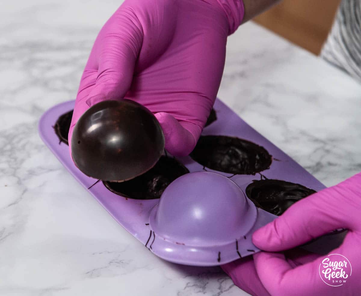 Removing chocolate from the half-sphere molds