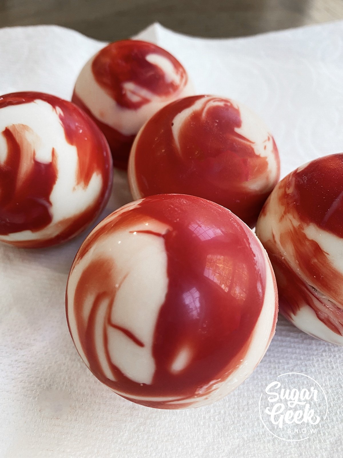 red and white marbled white chocolate bombs