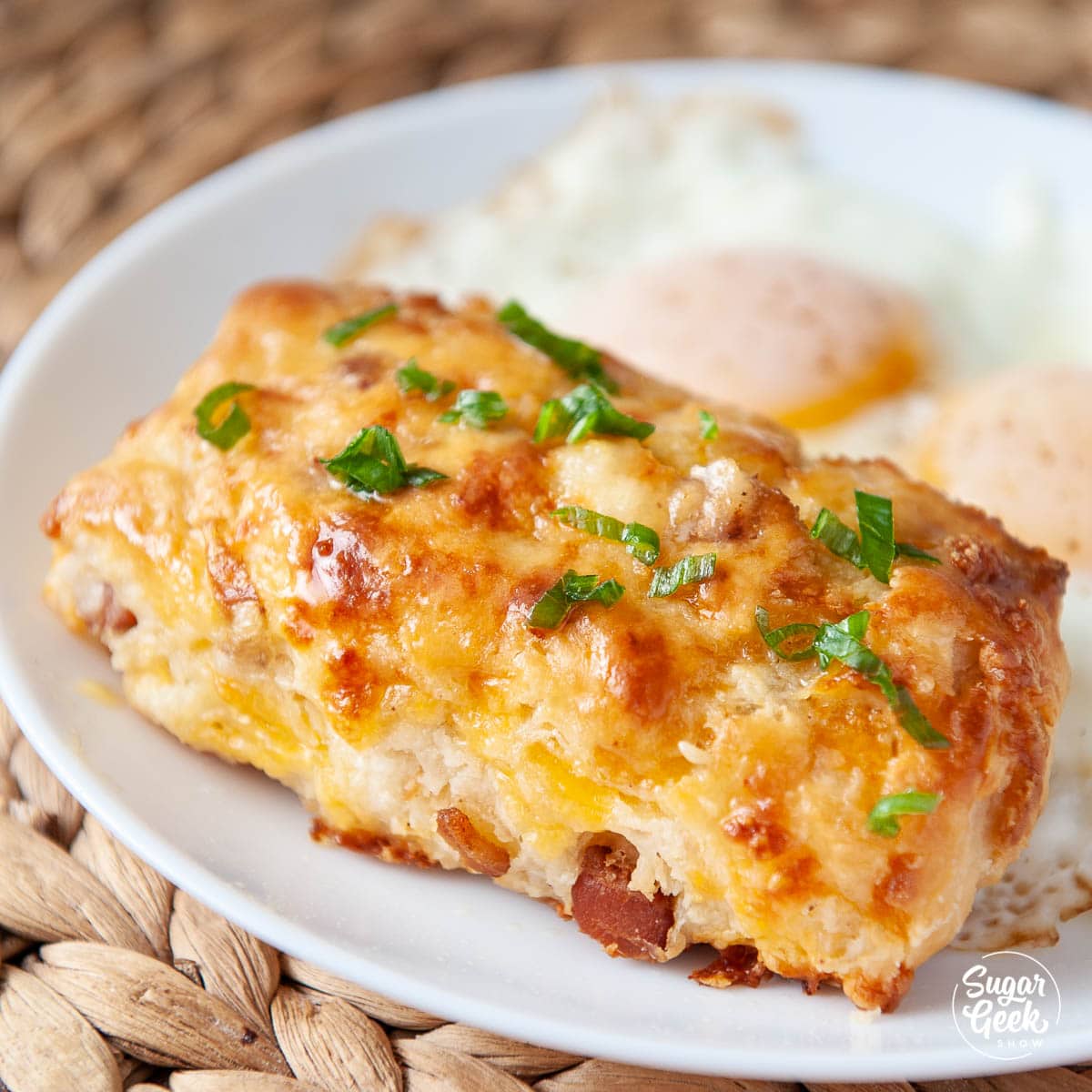 closeup of bacon cheddar scone with eggs