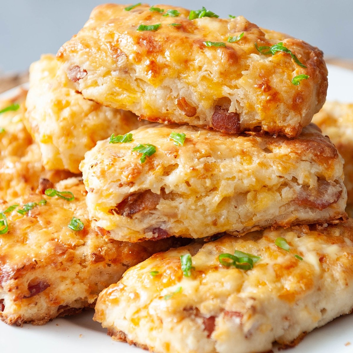 stack of bacon cheddar scones on a white plate
