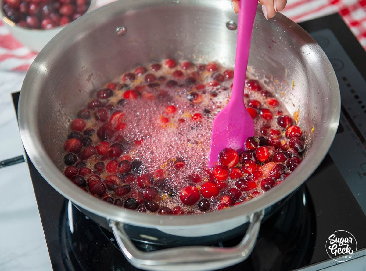 cranberry filling ingredients simmering in a stainless steel pot
