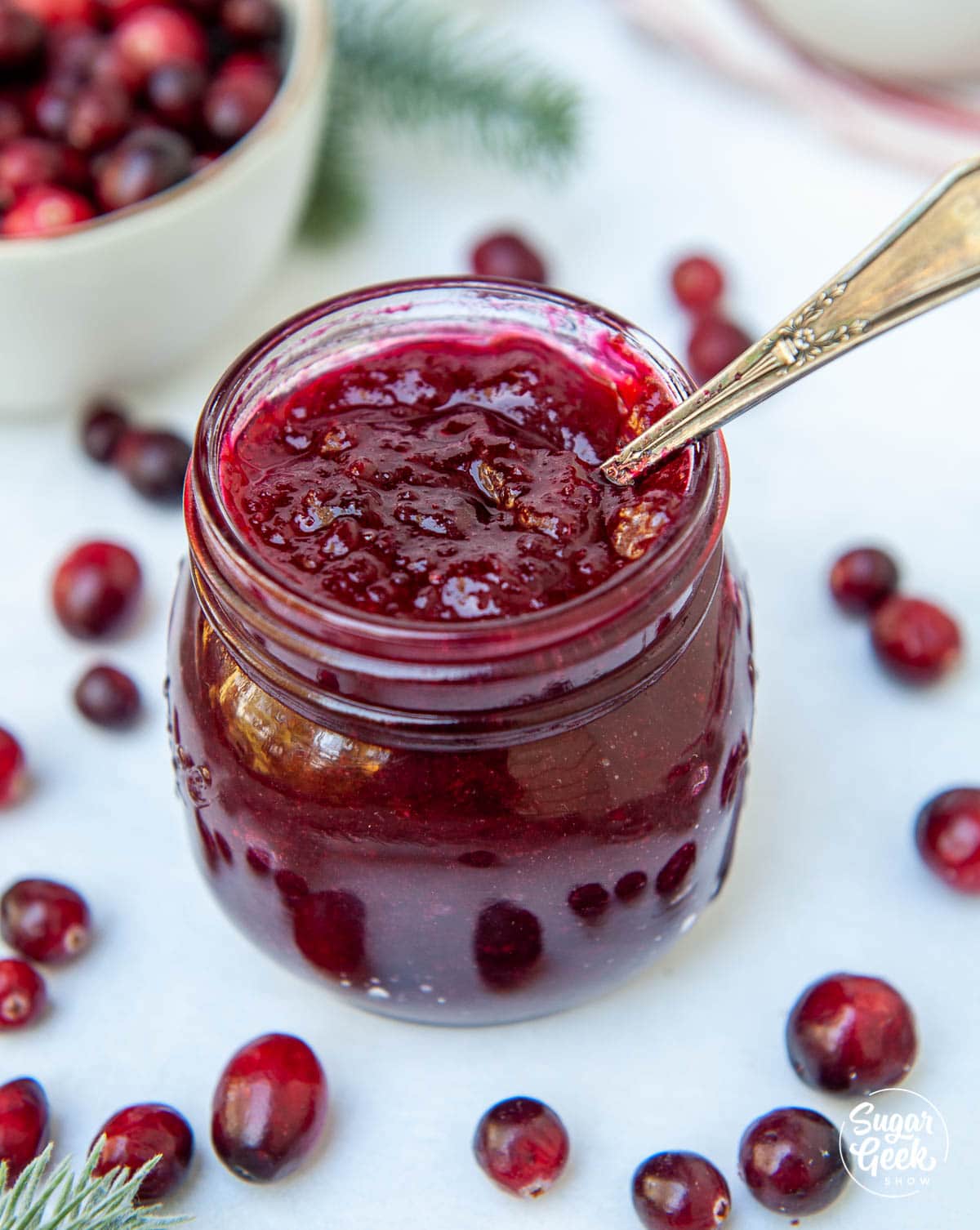 cranberry filling in a glass jar with a spoon