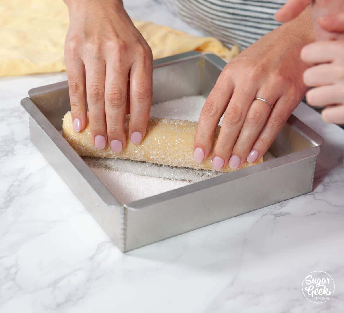 rolling lemon shortbread dough in sanding sugar