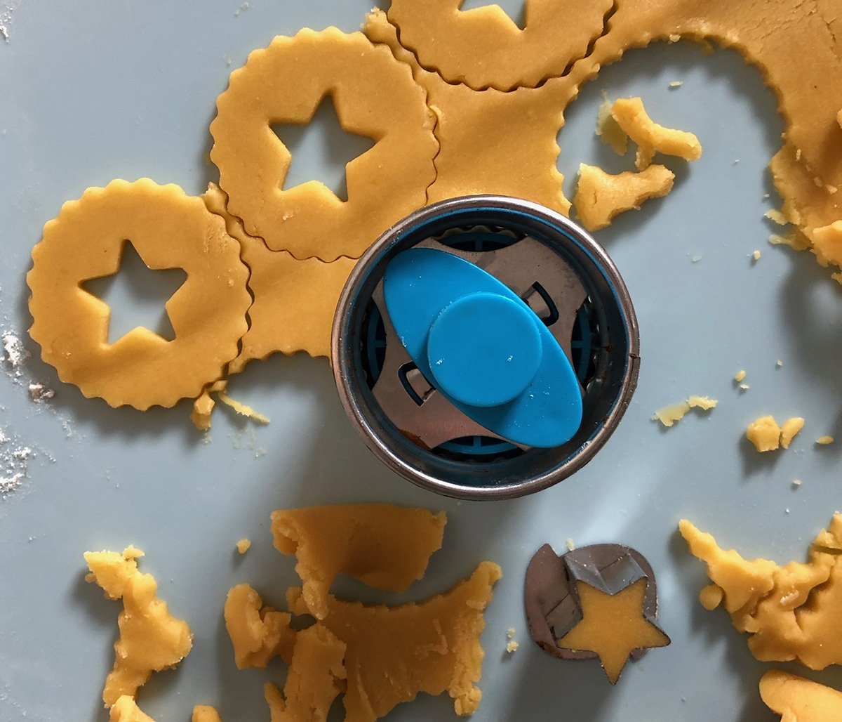 close up of linzer cookie cutter with cookie dough