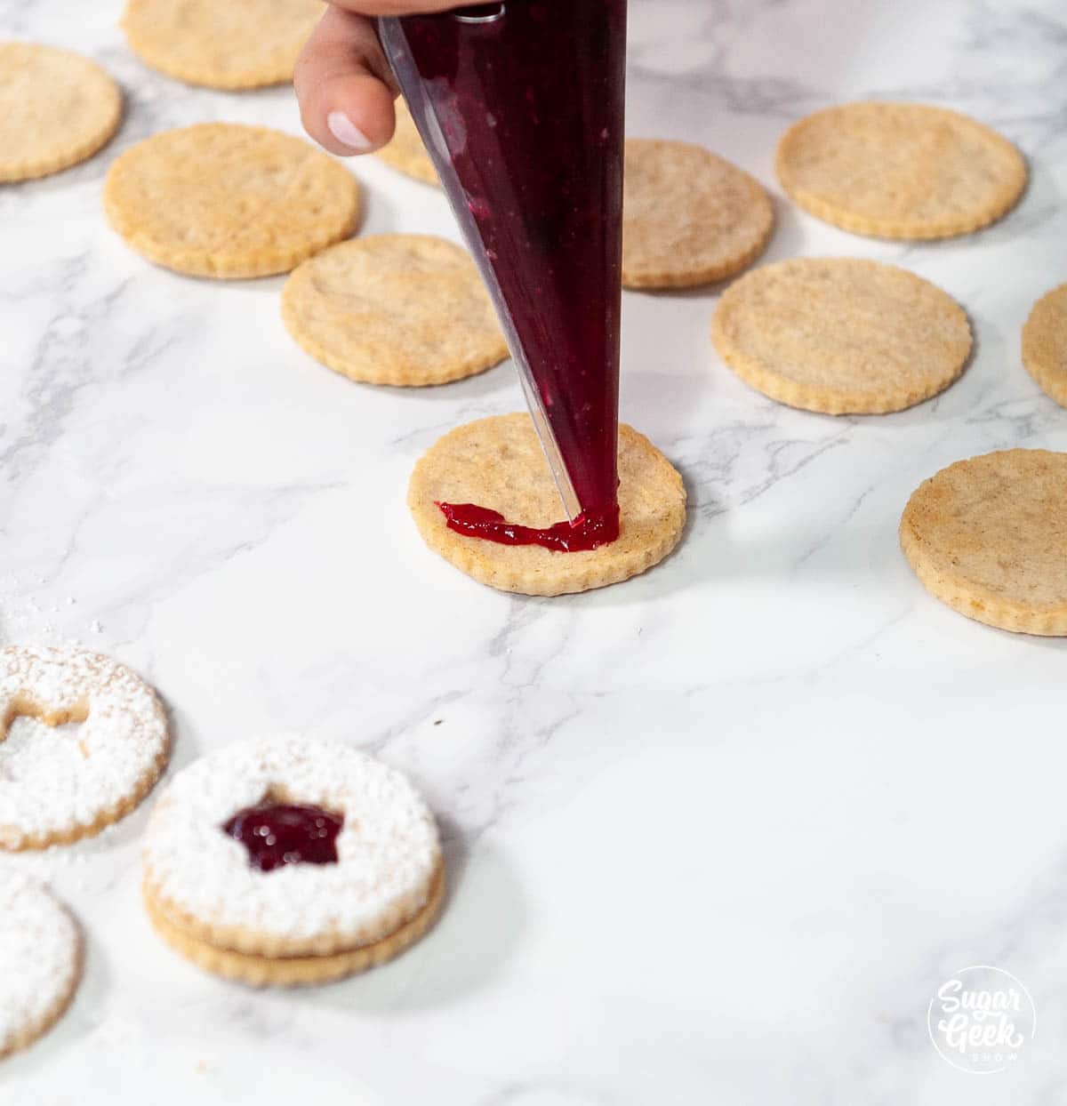 filling linzer cookies with cranberry filling