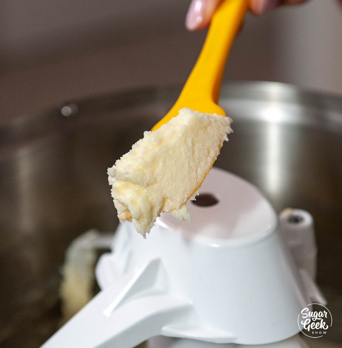 butter and sugar creamed together on an orange spatula
