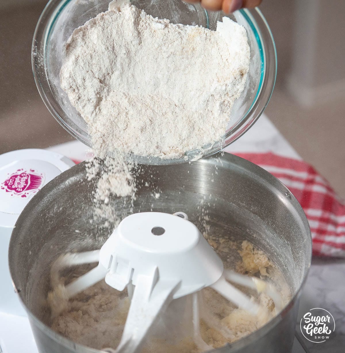 adding flour to the linzer cookie dough mixture