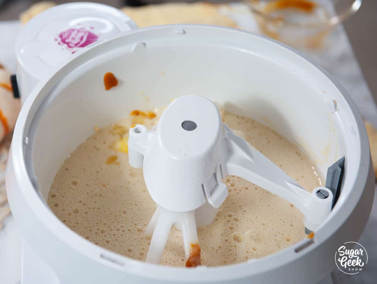 pumpkin spice cake liquid ingredients in a white mixing bowl