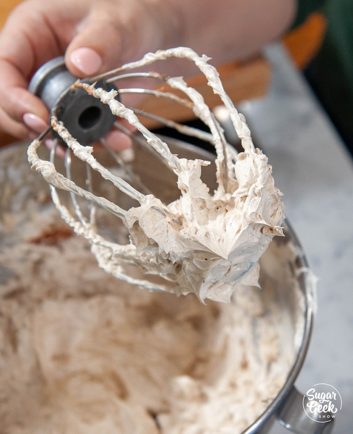 Close up of brown sugar buttercream on a whisk