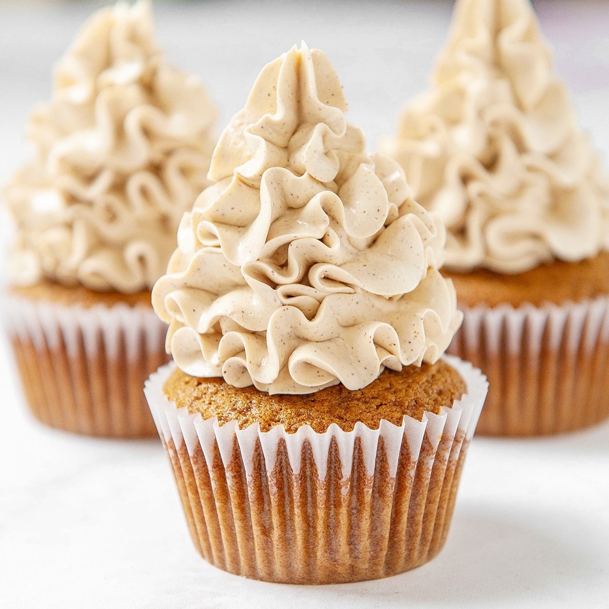 close up of brown sugar swiss meringue buttercream on a cupcake