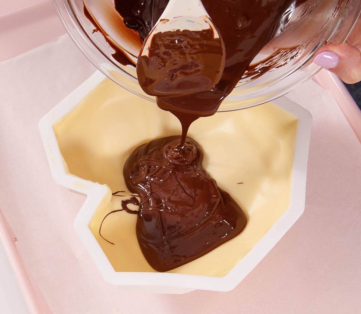 spatula spooning chocolate into white chocolate breakable heart