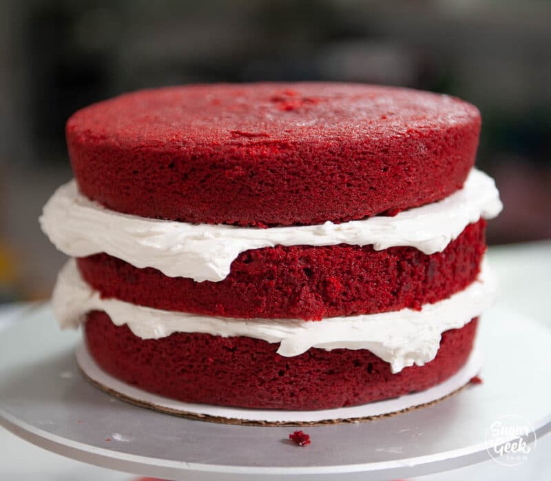three layers of doctored red velvet cake with buttercream