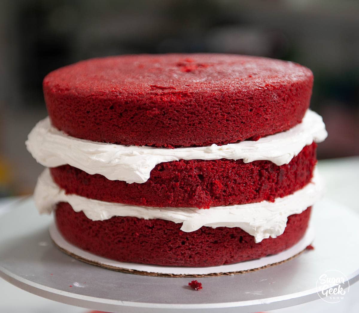 three layers of doctored red velvet cake with buttercream