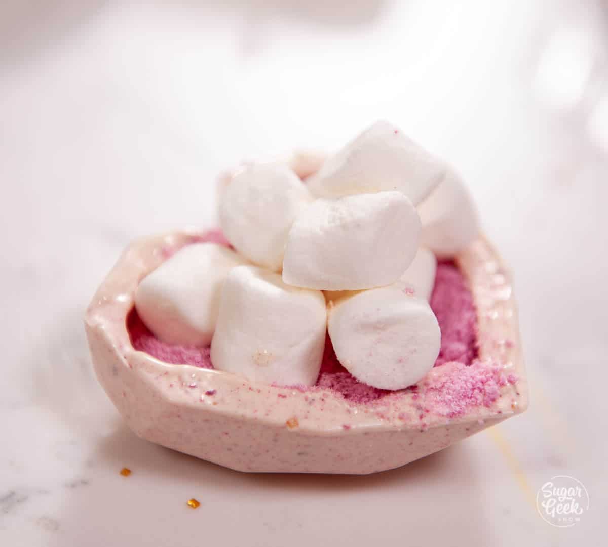 close up of chocolate heart with marshmallows on top