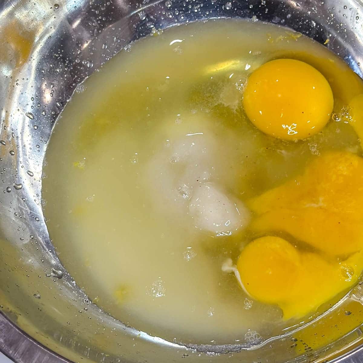 lemon curd ingredients in a metal bowl