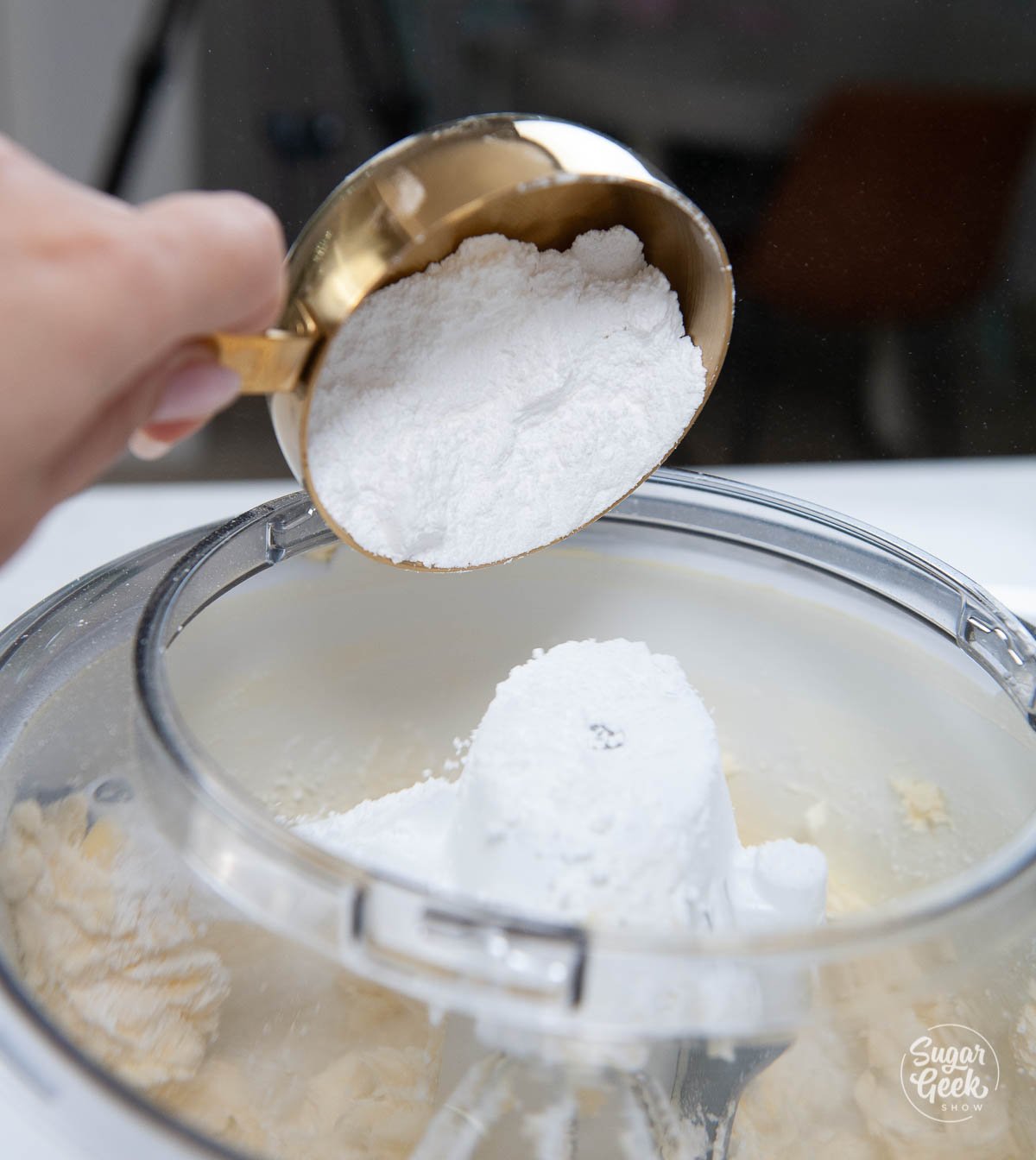 adding powdered sugar to creamed butter