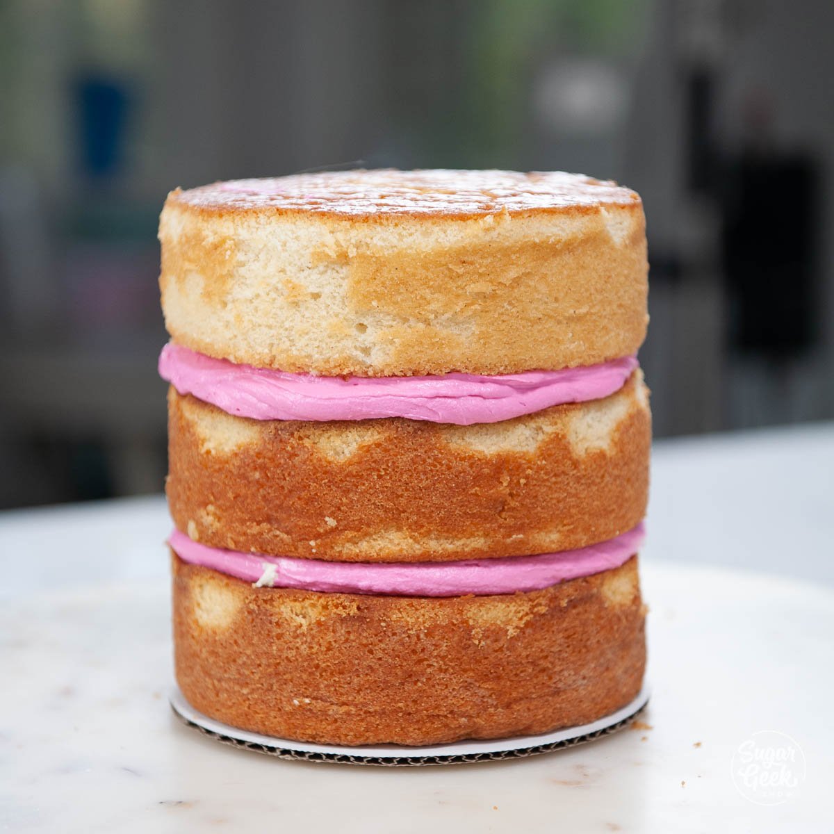 donut cake layers with pink buttercream