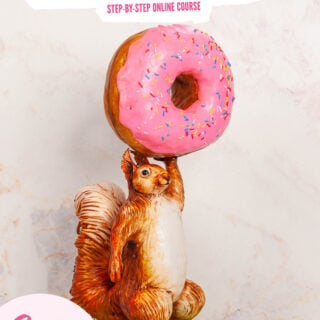 cake sculpted to look like a squirrel holding a giant donut