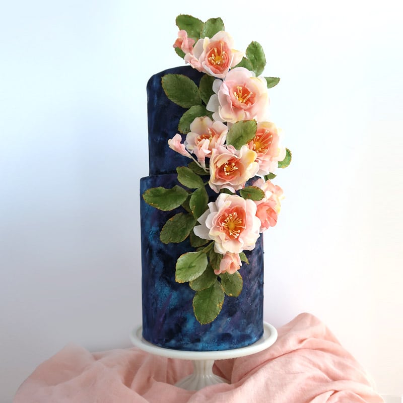 Wafer paper roses arranged on a textured wedding cake