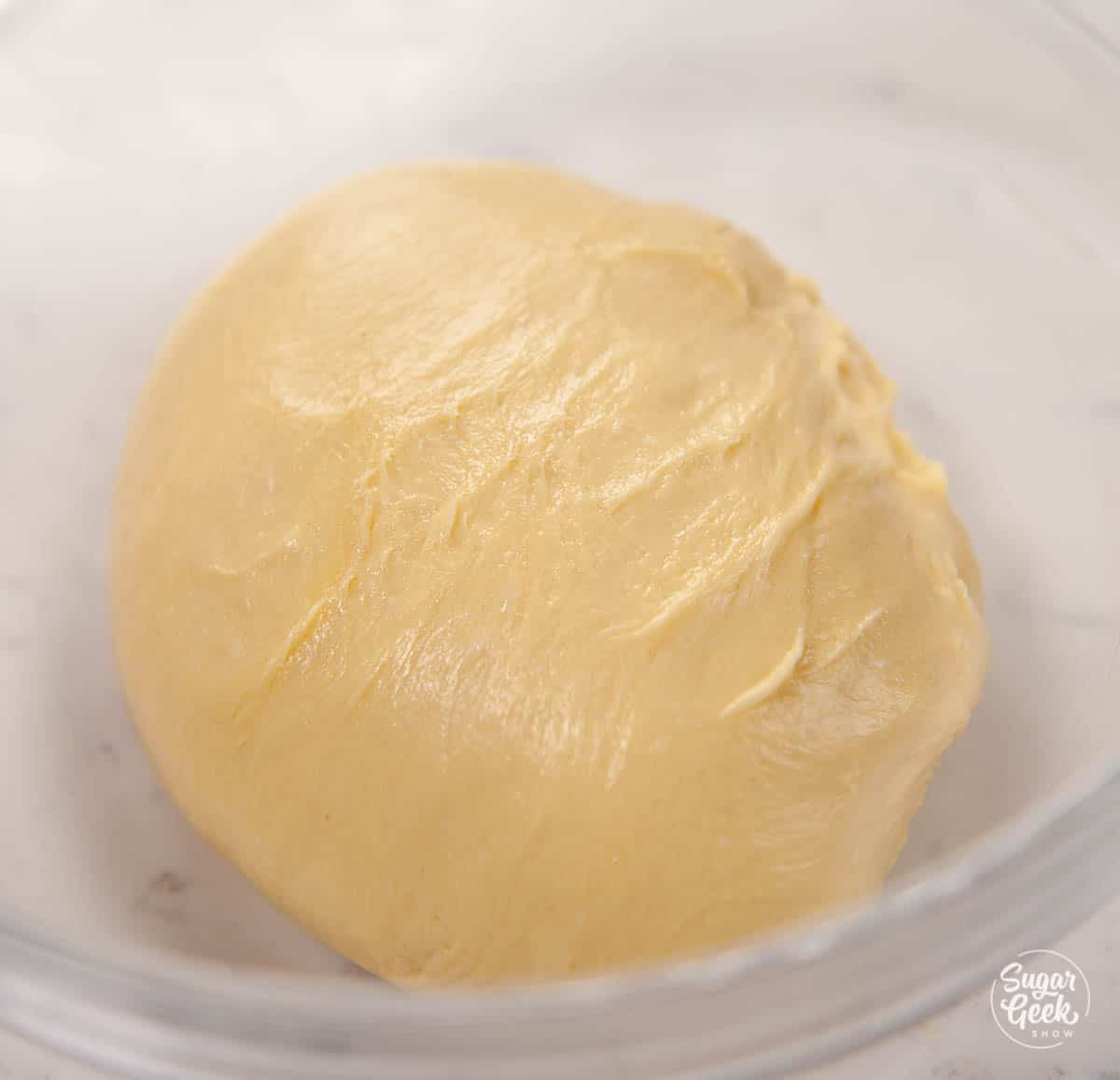 Brioche bread dough in a bowl.