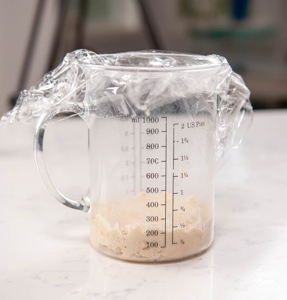 closeup of yeast mixture in a measuring cup