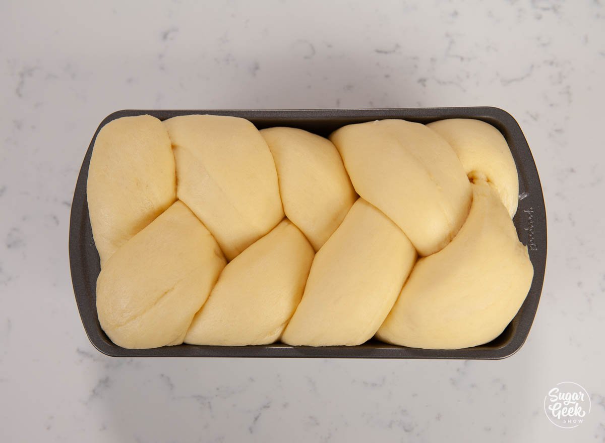 braided brioche bread in a bread pan