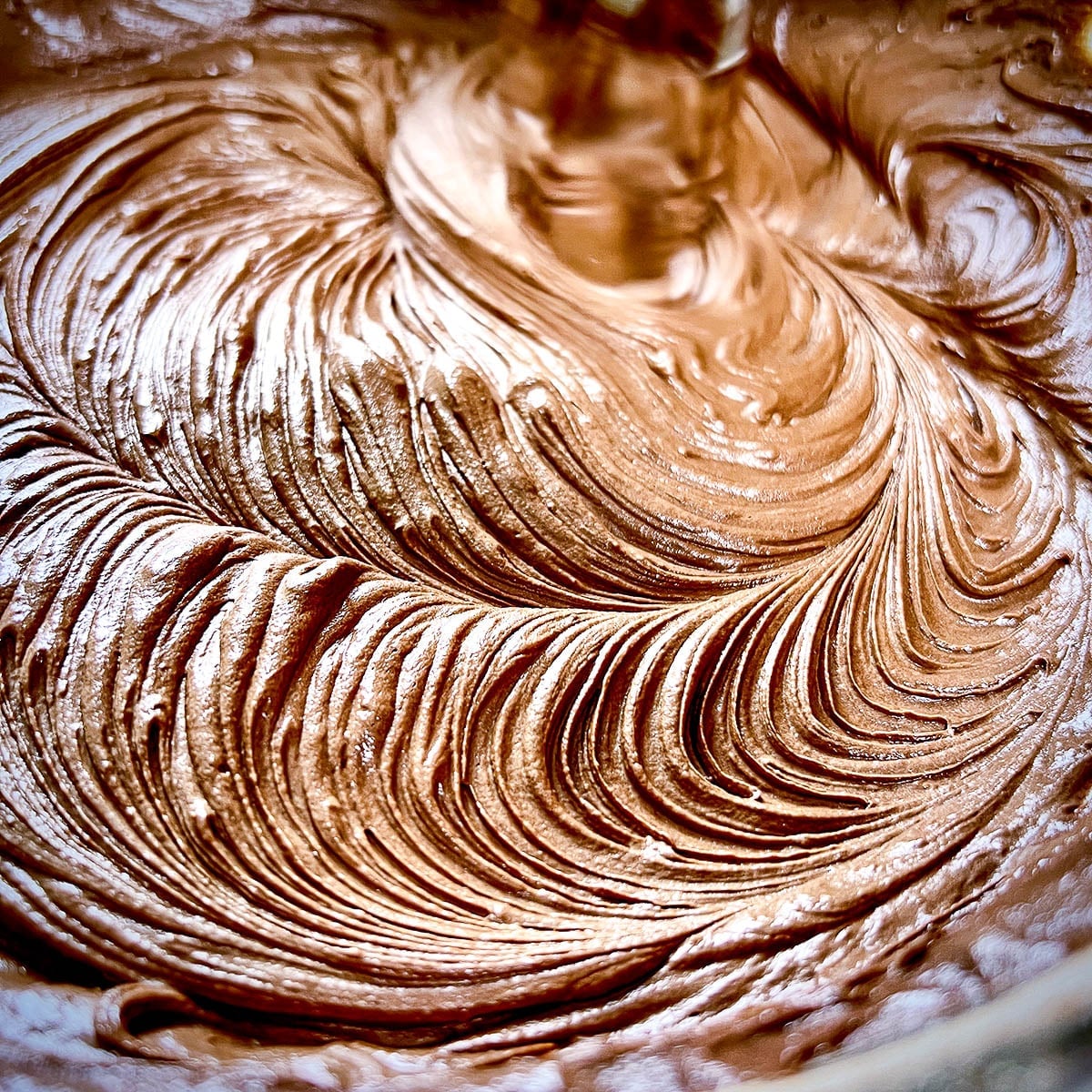 Chocolate frosting mixed in a bowl.