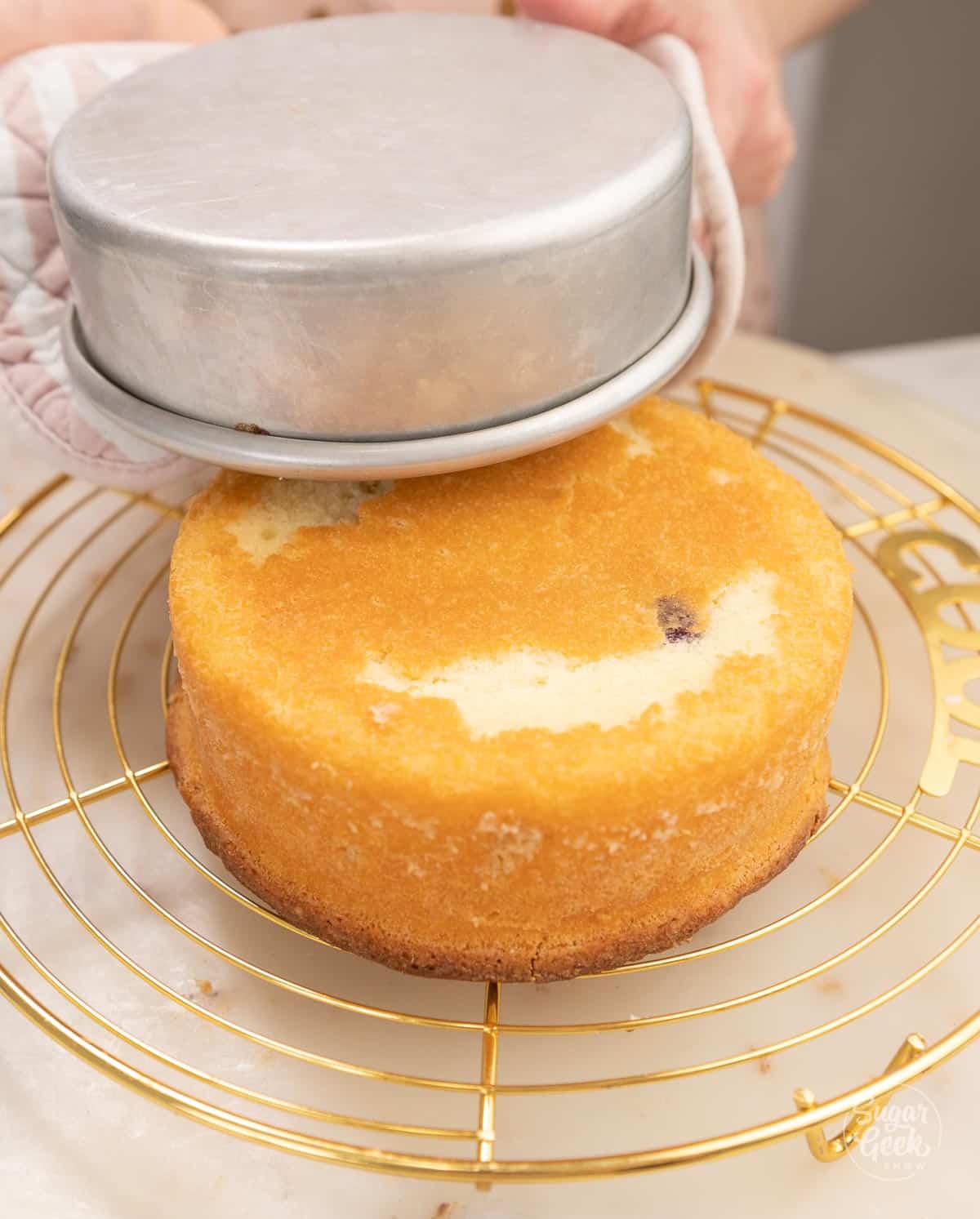 removing the lemon blueberry cake from the cake pan