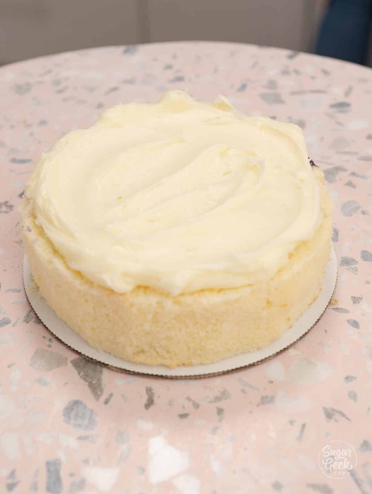layer of cream cheese frosting on lemon cake