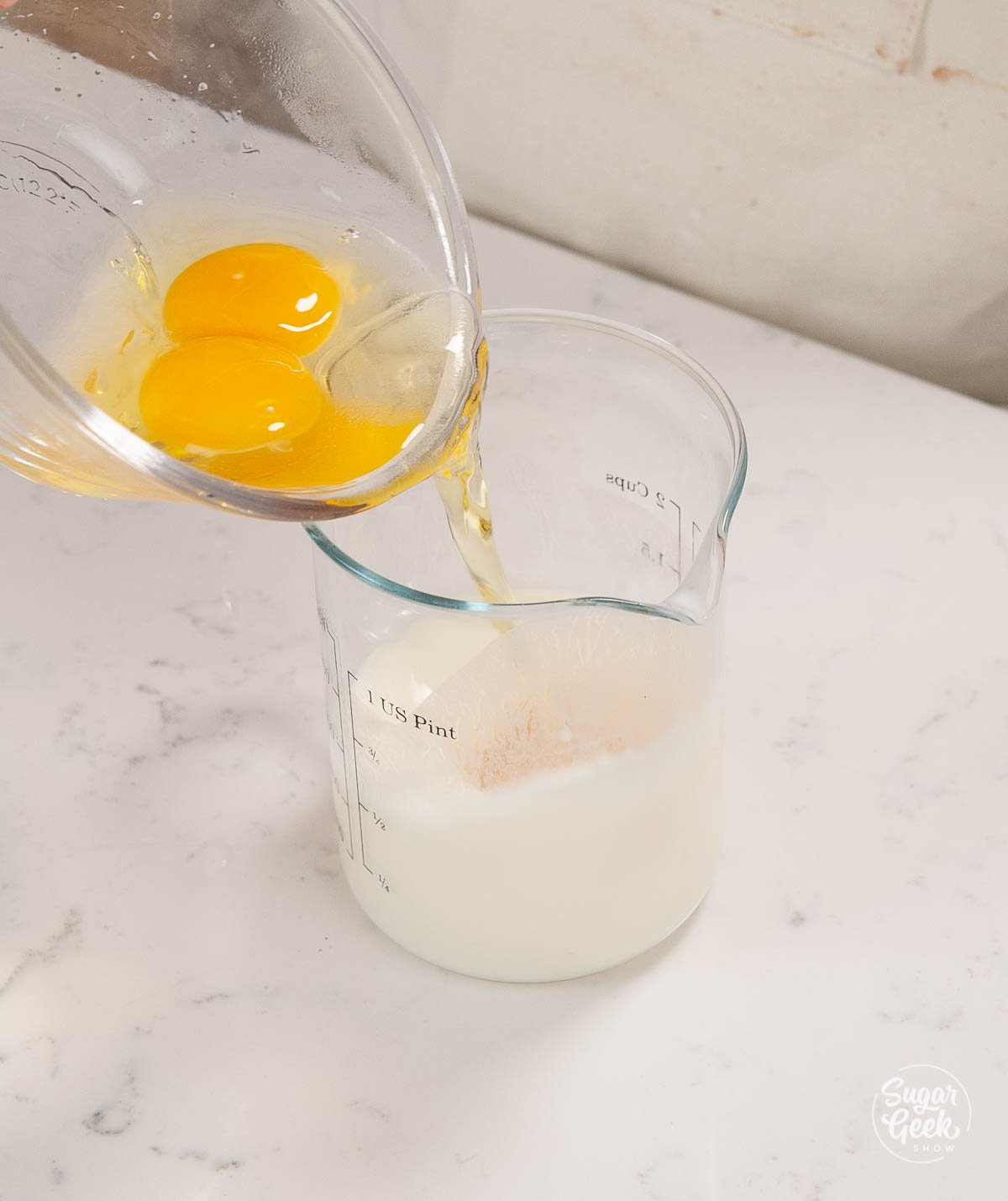 adding eggs to milk in a measuring cup