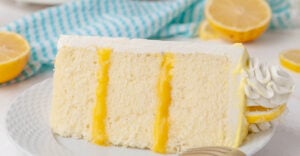 closeup of lemon cake slice on a white plate