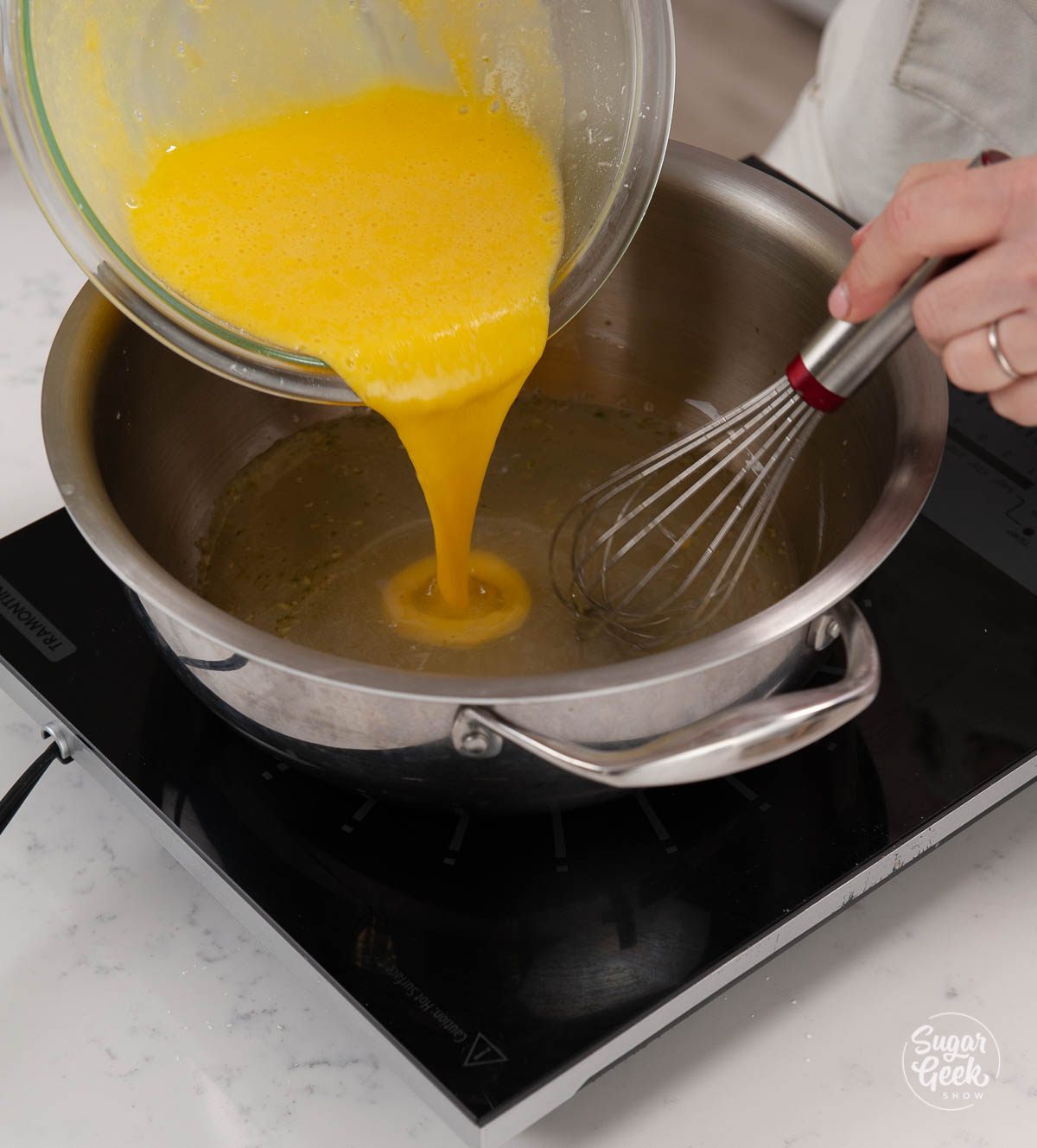 adding egg yolk mixture back to the hot lemon juice mixture