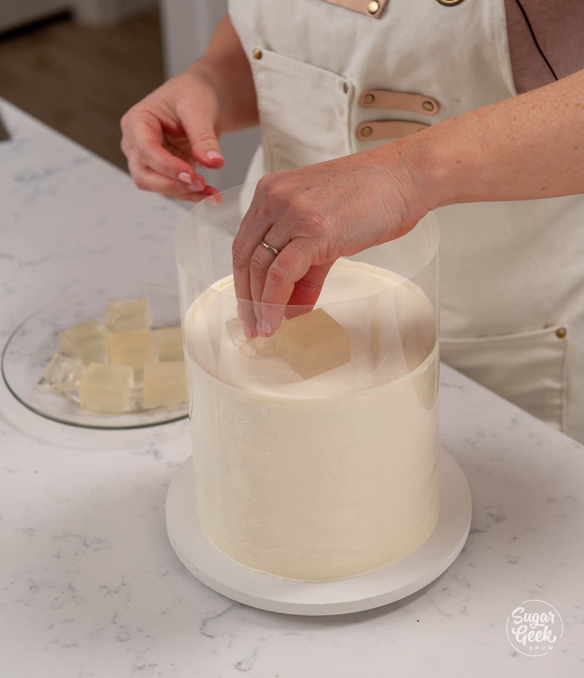 adding the margarita gelatin ice cubes to the top of the cake
