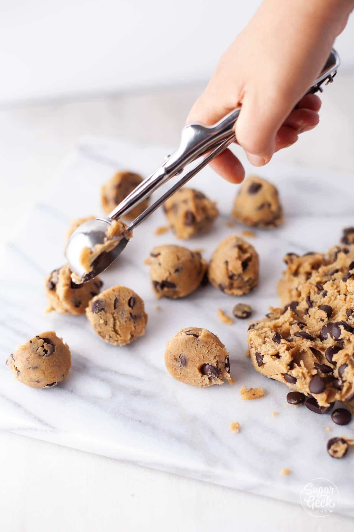 scooping chocolate chip cookie dough
