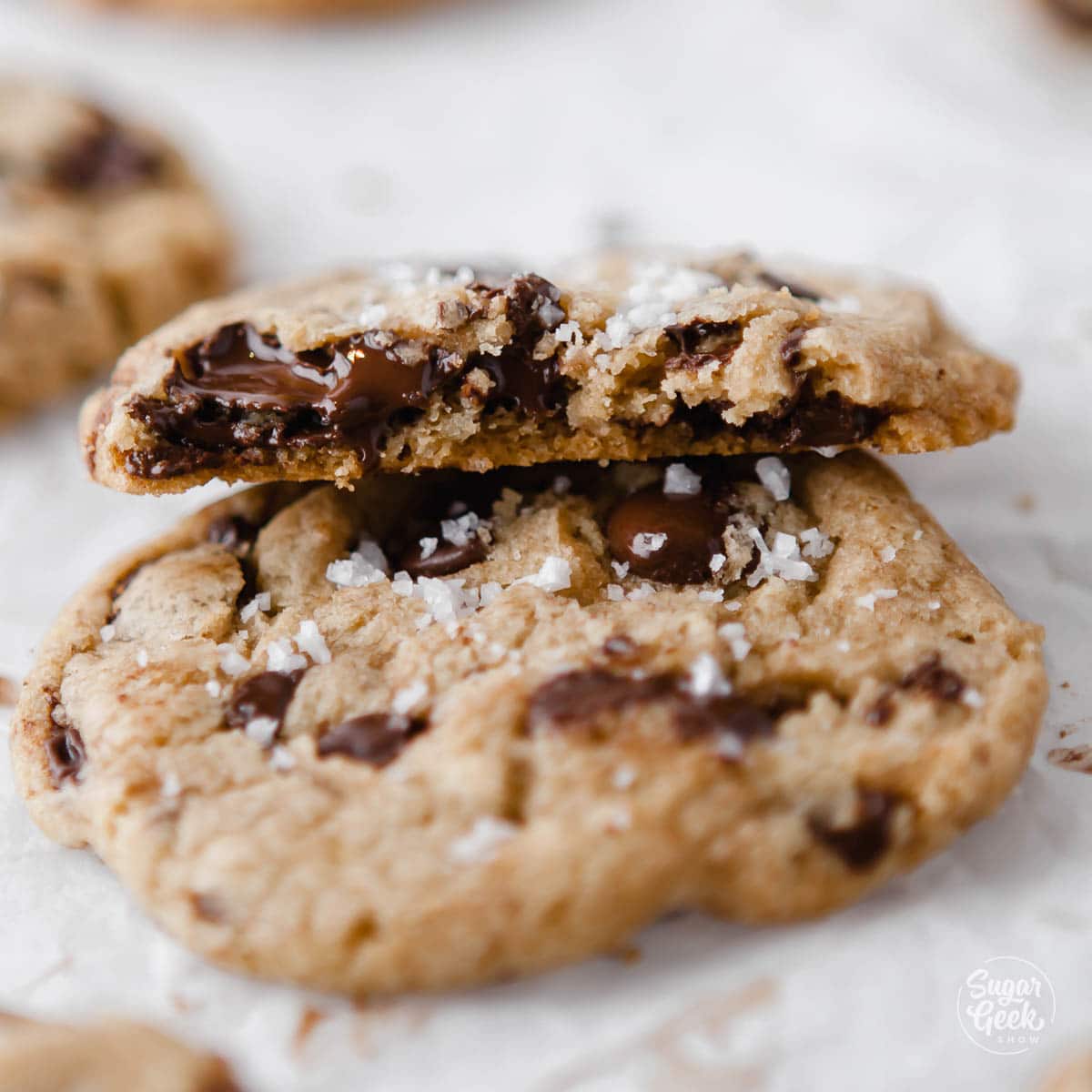 closeup of sea salt chocolate chip cookie on a white background