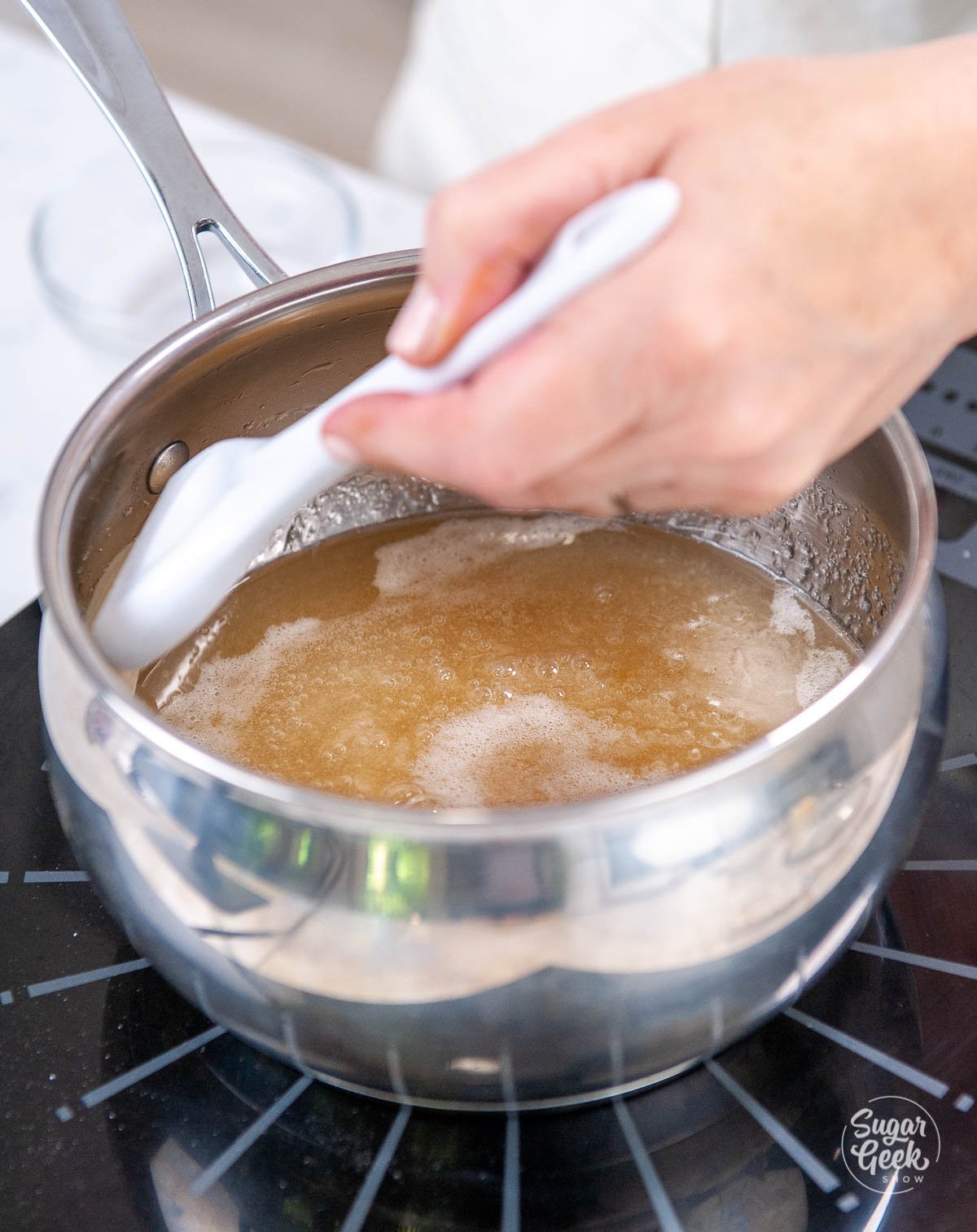 hand brushing the inside of a medium saucepan