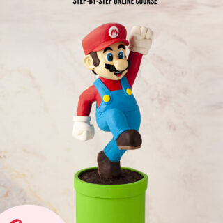 Cake sculpted to look like Super Mario jumping on a green tube