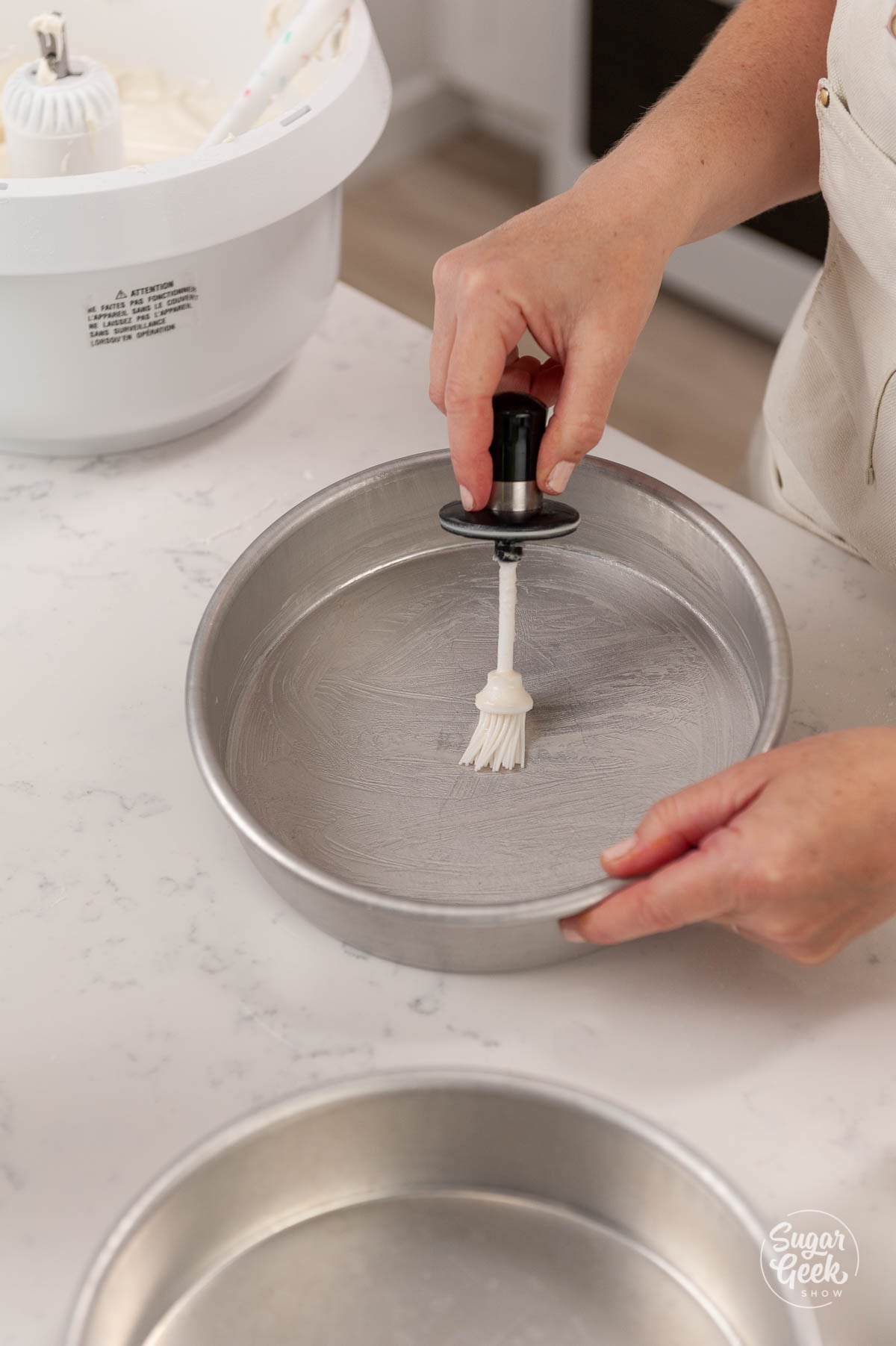 putting cake goop into cake pan