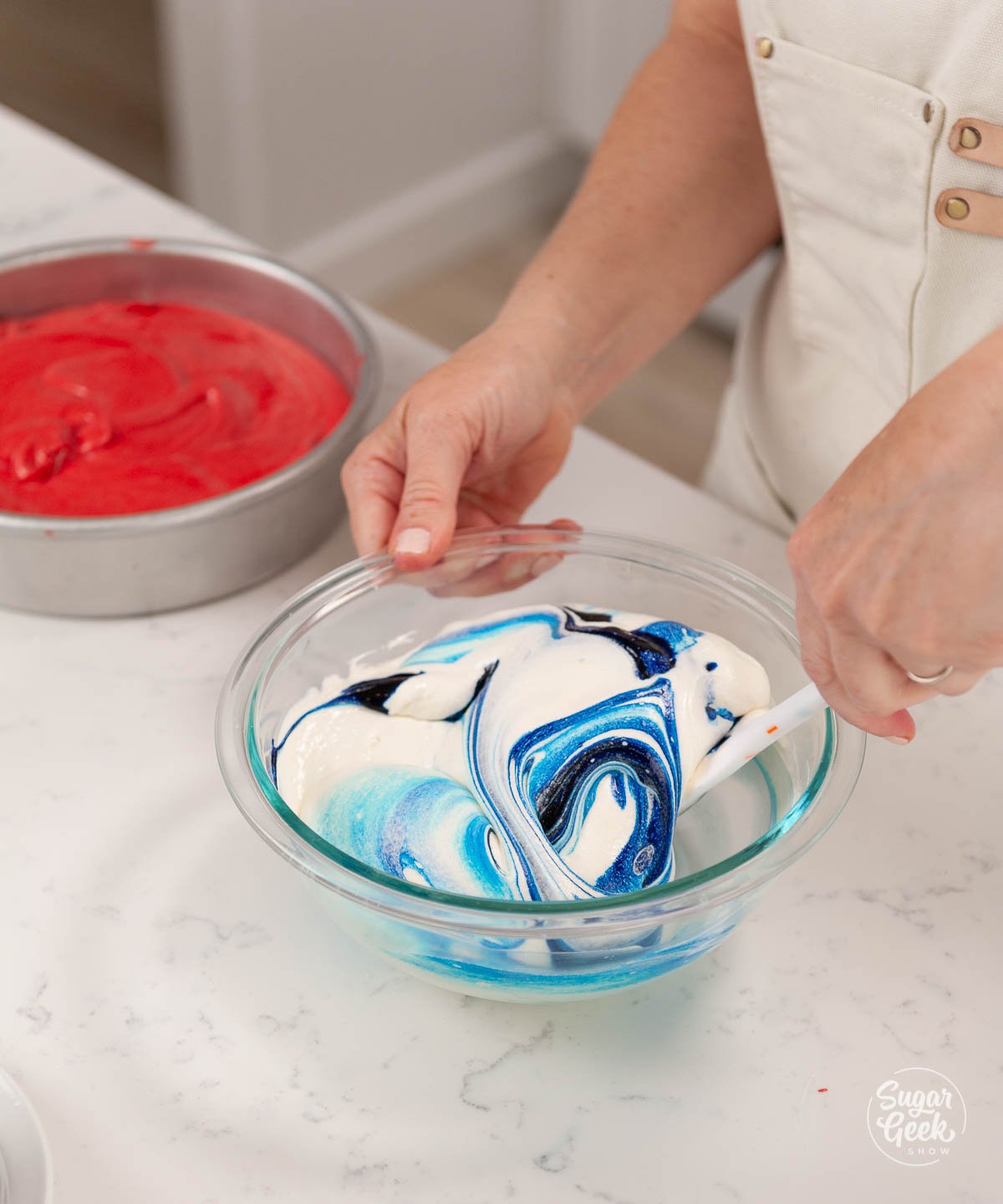 adding blue food coloring to white cake batter 