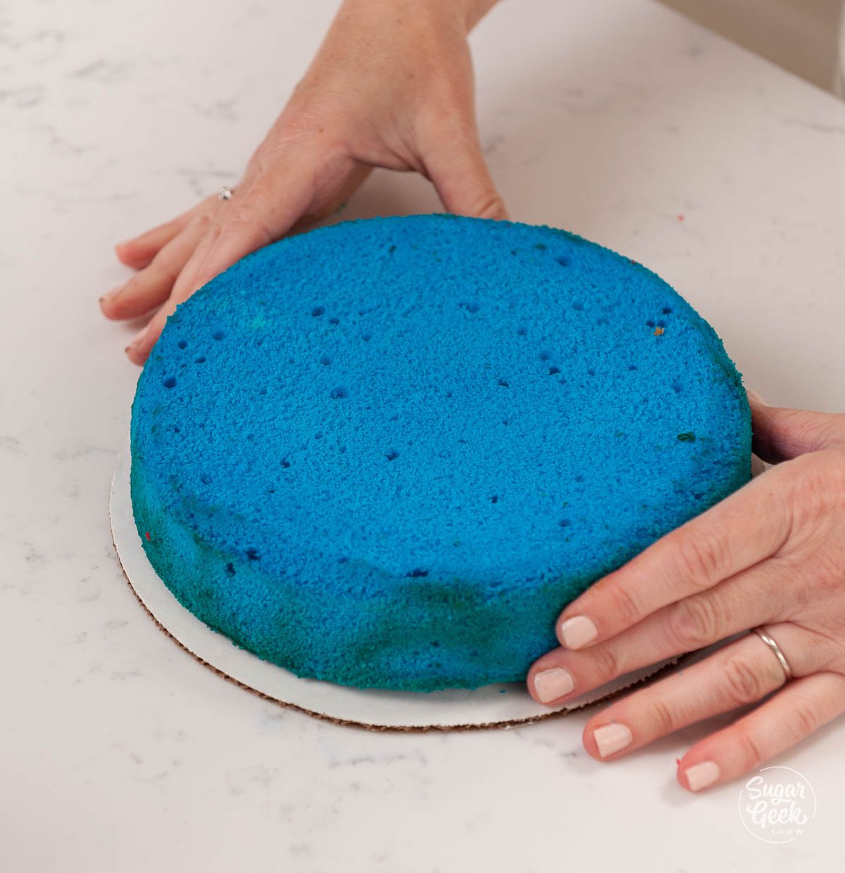 blue cake layer on a cake board