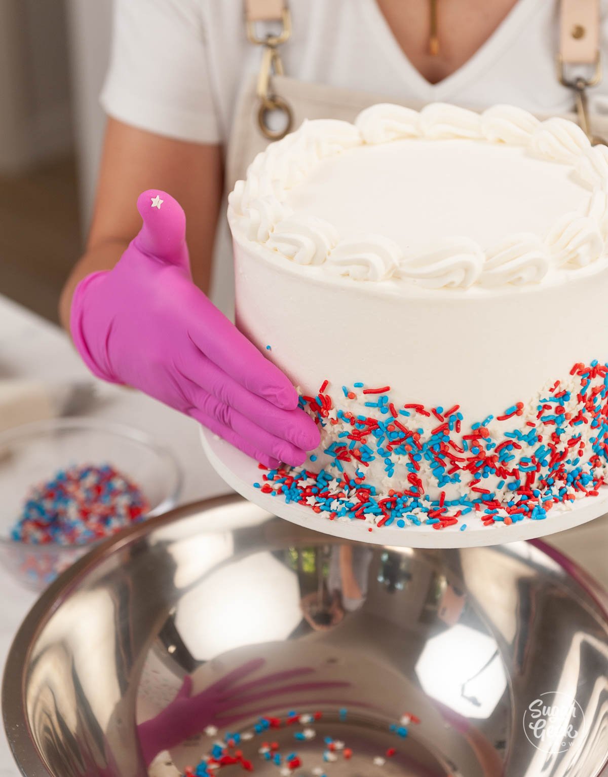 adding red white and blue sprinkles to the ice cream cake