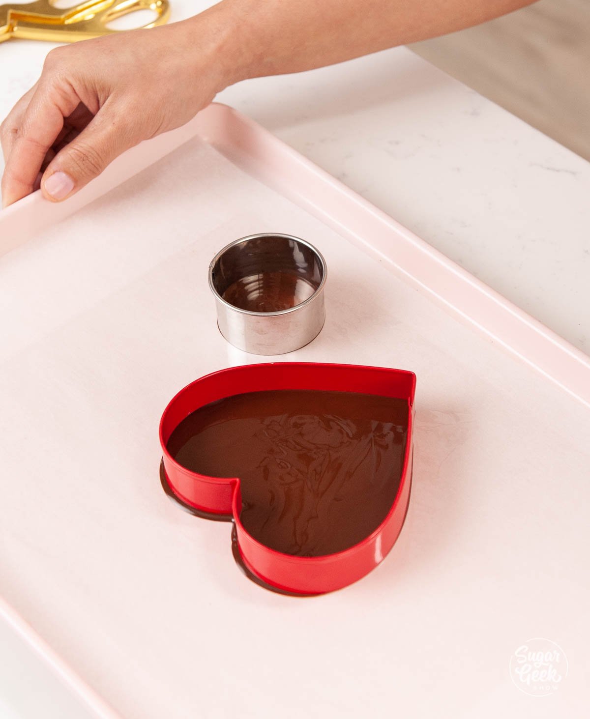 tempered chocolate inside a heart and circle cookie cutter