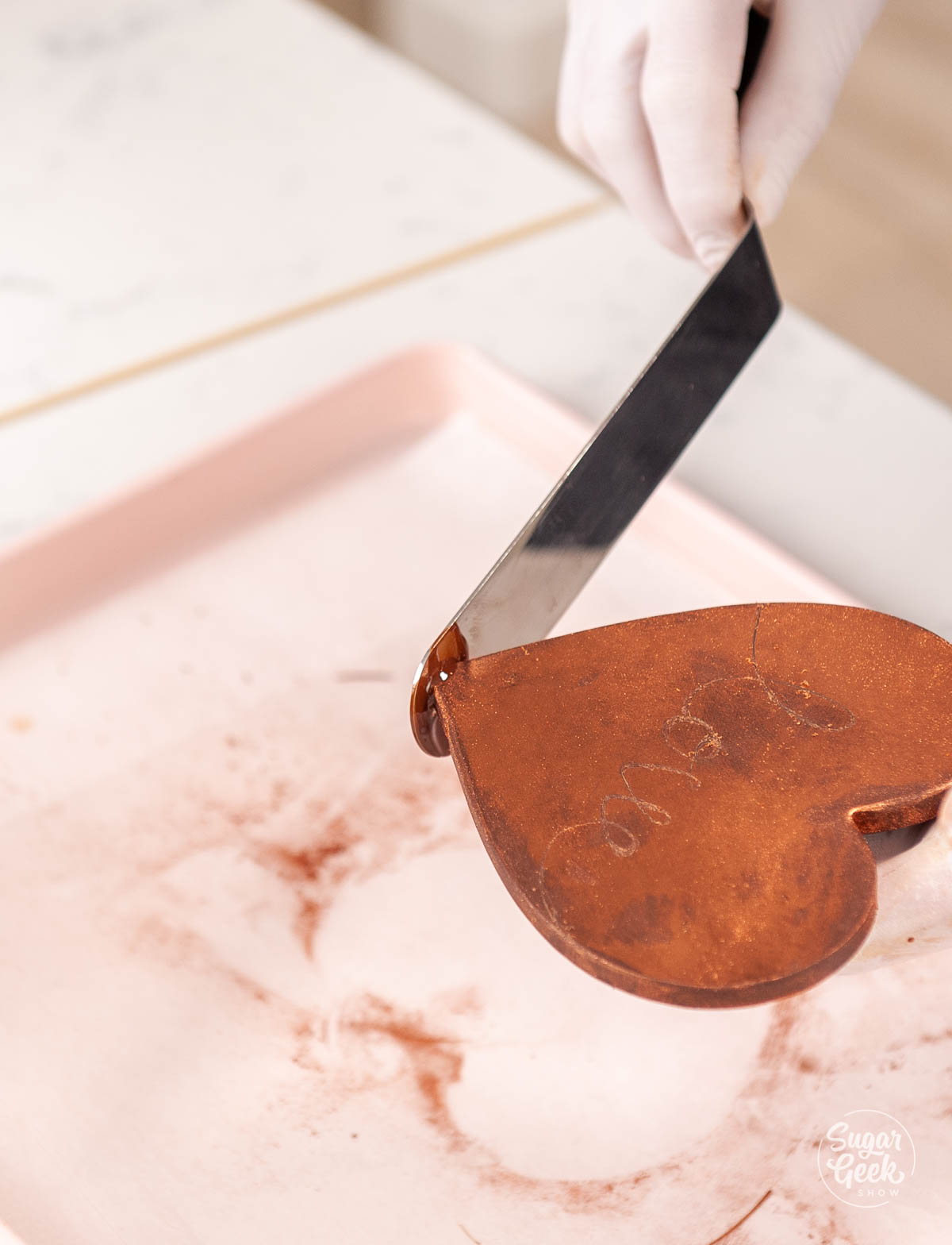 melting the tip of the chocolate heart with hot spatula