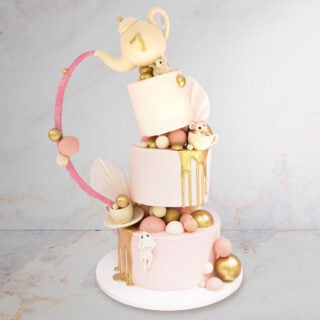 Topsy turvy Cake with teacups and mouses sculpted on it
