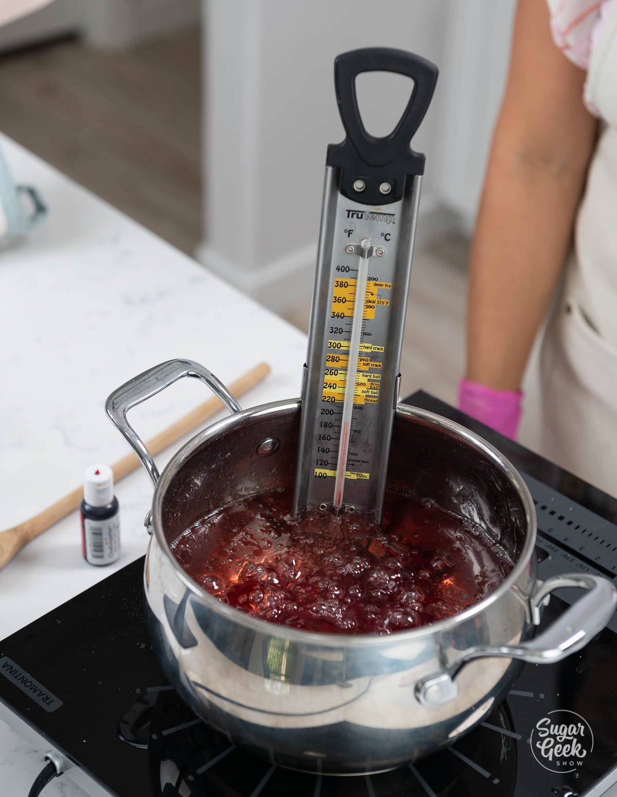 candy thermometer in candy apple mixture